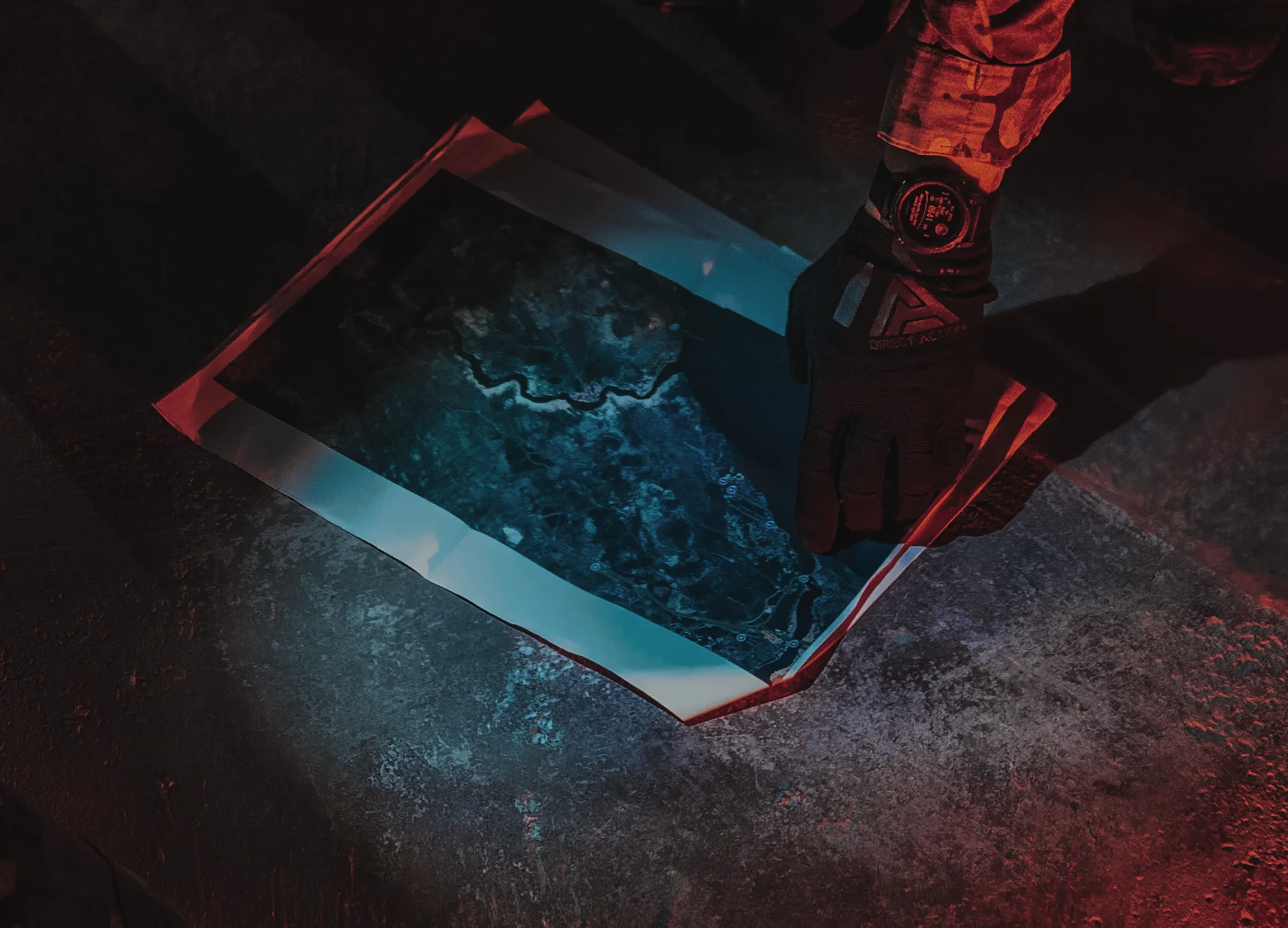 Field map under tactical light with a gloved hand
